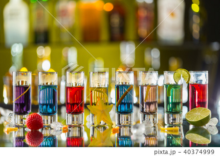 Colored alcoholic shots on bar counter 40374999