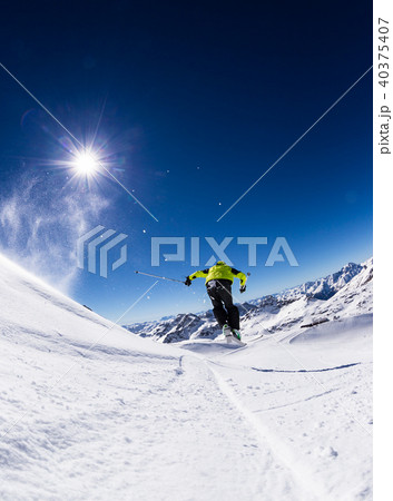 Alpine skier on piste, skiing downhill 40375407