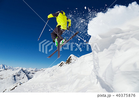 Alpine skier on piste, skiing downhill 40375876