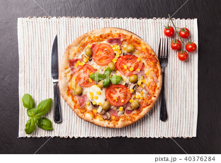 Delicious fresh pizza served on black stone Delicious fresh pizza served on black stone 40376284