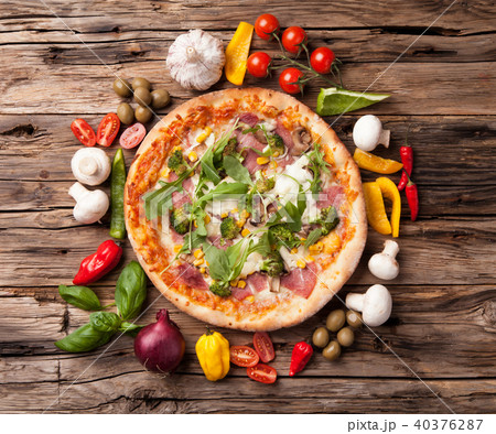 Delicious fresh pizza served on wooden table Delicious fresh pizza served on wooden table 40376287
