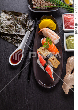 Delicious sushi pieces served on black stone 40376377