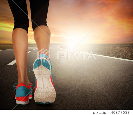Runner feet running on road Runner feet running on road 40377058