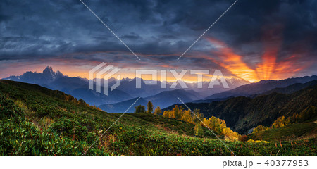 Sunset over snow-capped mountain peaks. 40377953
