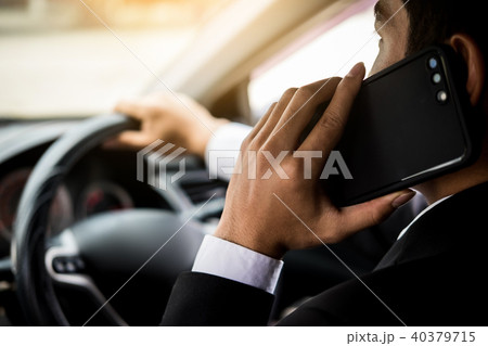 Attractive handsome young businessman using mobile smart phone i 40379715