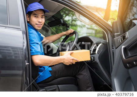 Delivery messenger man with cardboard box  outside the warehouse 40379716