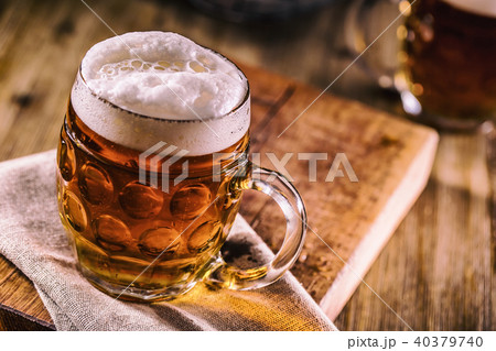 Close-up cold draft beer on wooden board Close-up cold draft beer on wooden board 40379740