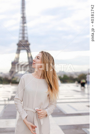 Pretty female person smiling with soft focus Eiffel Tower background. 40381742
