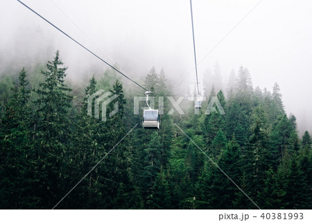 Cable car in mountain a foggy day Cable car in mountain a foggy day 40381993