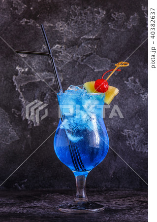 Blue Curacao cocktail decorated with fruit. 40382637