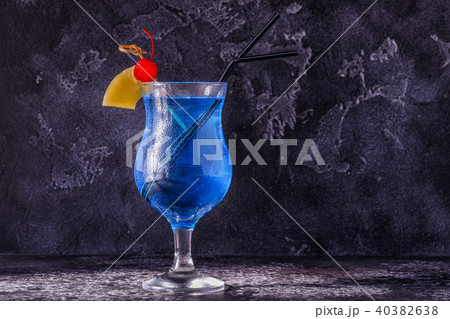 Blue Curacao cocktail decorated with fruit. 40382638