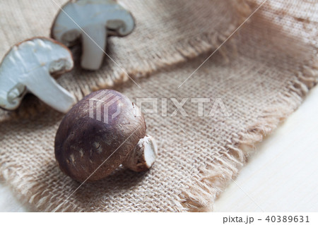 Raw and fresh mushrooms on sackcloth Raw and fresh mushrooms on sackcloth 40389631