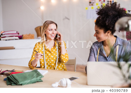 Young creative women with laptop in studio, startup business. 40390789