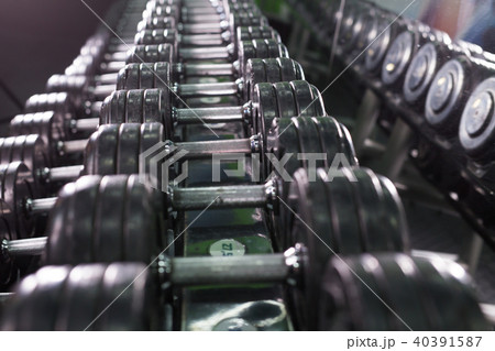 Black dumbbell set in sport fitness center. Weight Training Equipment concept. 40391587