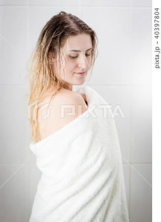 Beautiful young woman in white towel after having shower Beautiful young woman in white towel after having shower 40397804