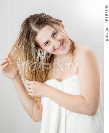 Portrait of happy young woman wiping after shower and looking in camera Portrait of happy young woman wiping after shower and looking in camera 40397846