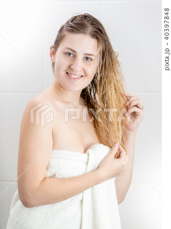 Portrait of young woman with long blond hair looking in camera after having shower Portrait of young woman with long blond hair looking in camera after having shower 40397848