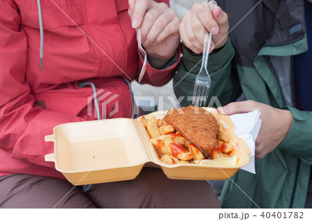 Young couple is eating food fish and chips Young couple is eating food fish and chips 40401782