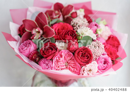 Bright red bouquet of beautiful flowers on wooden table. Floristry concept. Spring colors. the work 40402488
