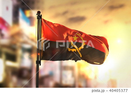 Angola Flag Against City Blurred Background 40405377