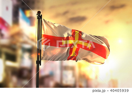 Guernsey Flag Against City Blurred Background 40405939