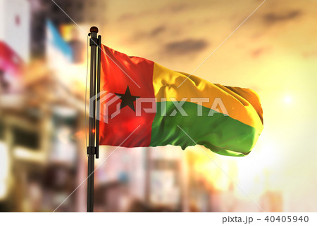 Guinea-Bissau Flag Against City Blurred Background Guinea-Bissau Flag Against City Blurred Background 40405940