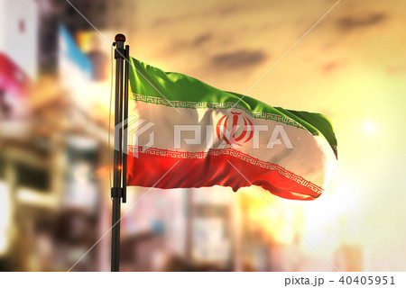 Iran Flag Against City Blurred Background 40405951