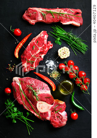 Raw meat steaks with cherry tomatoes, hot pepper Raw meat steaks with cherry tomatoes, hot pepper 40407129