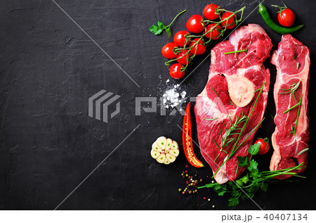 Raw meat steaks with cherry tomatoes, hot pepper Raw meat steaks with cherry tomatoes, hot pepper 40407134