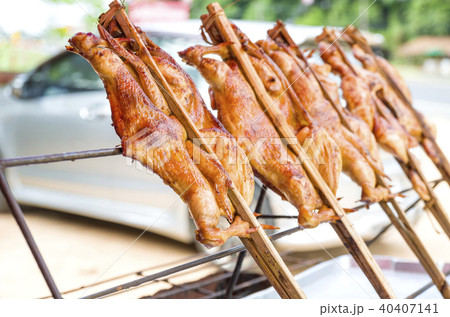 The whole roasted chicken in bamboo. The grilled The whole roasted chicken in bamboo. The grilled 40407141