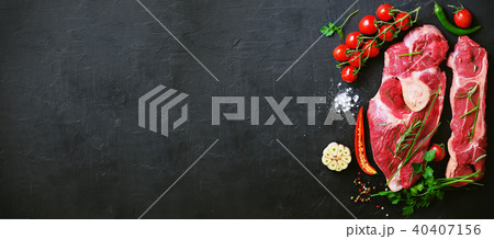 Raw meat steaks with cherry tomatoes, hot pepper Raw meat steaks with cherry tomatoes, hot pepper 40407156