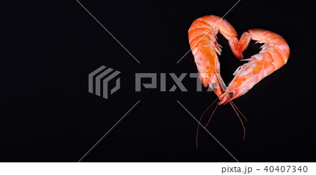 Two shrimps forming a heart in a black background. 40407340