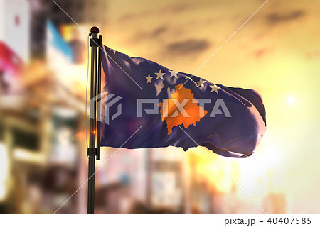Kosovo Flag Against City Blurred Background 40407585
