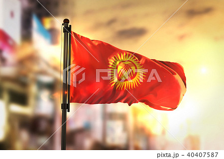 Kyrgyzstan Flag Against City Blurred Background 40407587