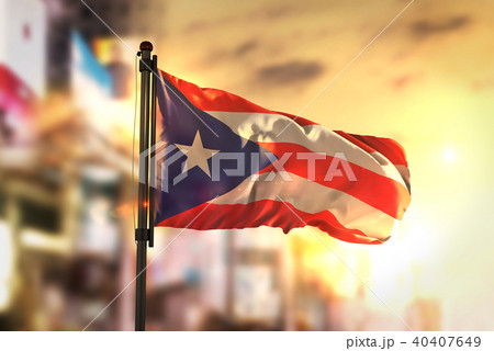 Puerto Rico Flag Against City Blurred Background Puerto Rico Flag Against City Blurred Background 40407649