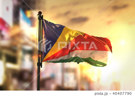 Seychelles Flag Against City Blurred Background Seychelles Flag Against City Blurred Background 40407790