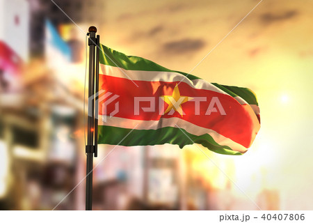 Suriname Flag Against City Blurred Background Suriname Flag Against City Blurred Background 40407806