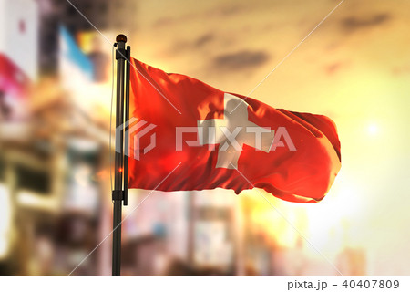 Switzerland Flag Against City Blurred Background 40407809