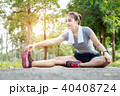 Young woman stretching her leg before exercise 40408724