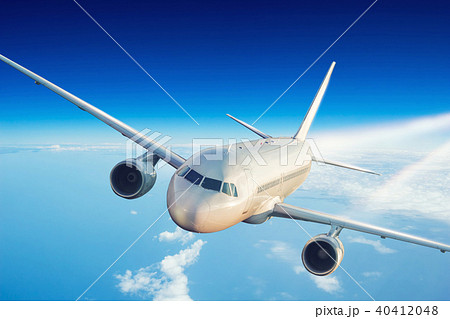Commercial jet plane flying above clouds 40412048