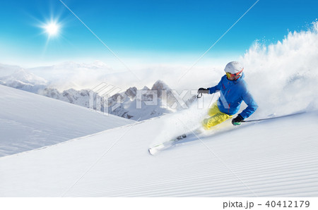 Skier skiing downhill in high mountains 40412179