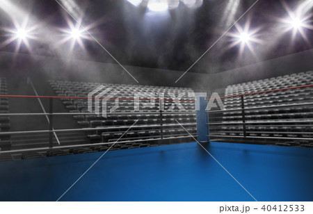 Empty boxing ring in arena, spot lights, smoke and dark night scene 40412533