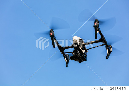 Drone flying against blue sky background Drone flying against blue sky background 40413456