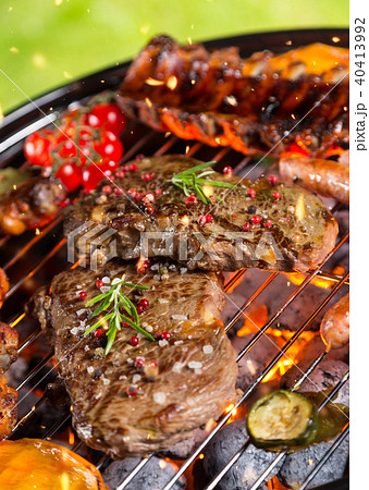 Various kind of meat served on grill 40413992