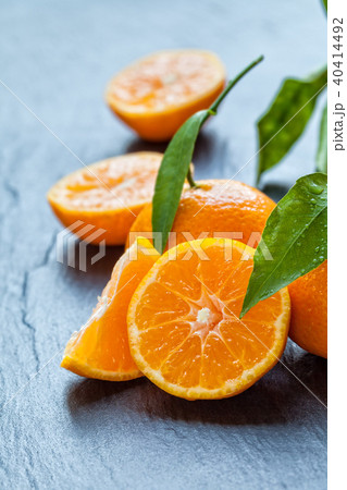 Fresh mandarin on black stone Fresh mandarin on black stone 40414492