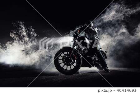 High power motorcycle chopper with man rider at night 40414693