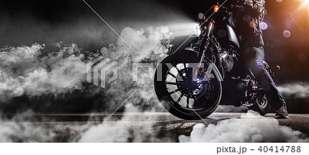 Close-up of high power motorcycle chopper with man rider at night 40414788