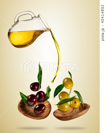 Olive oil with flying olives in wooden bowls 40414892
