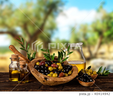 Fresh harvested olives with oil, placed on wooden table 40414942