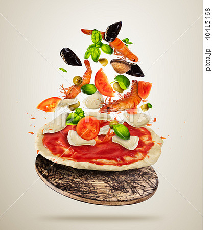 Flying sea food ingredients with pizza dough, on gray background Flying sea food ingredients with pizza dough, on gray background 40415468